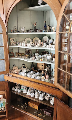 Cabinet filled with decorative ceramics and figurines